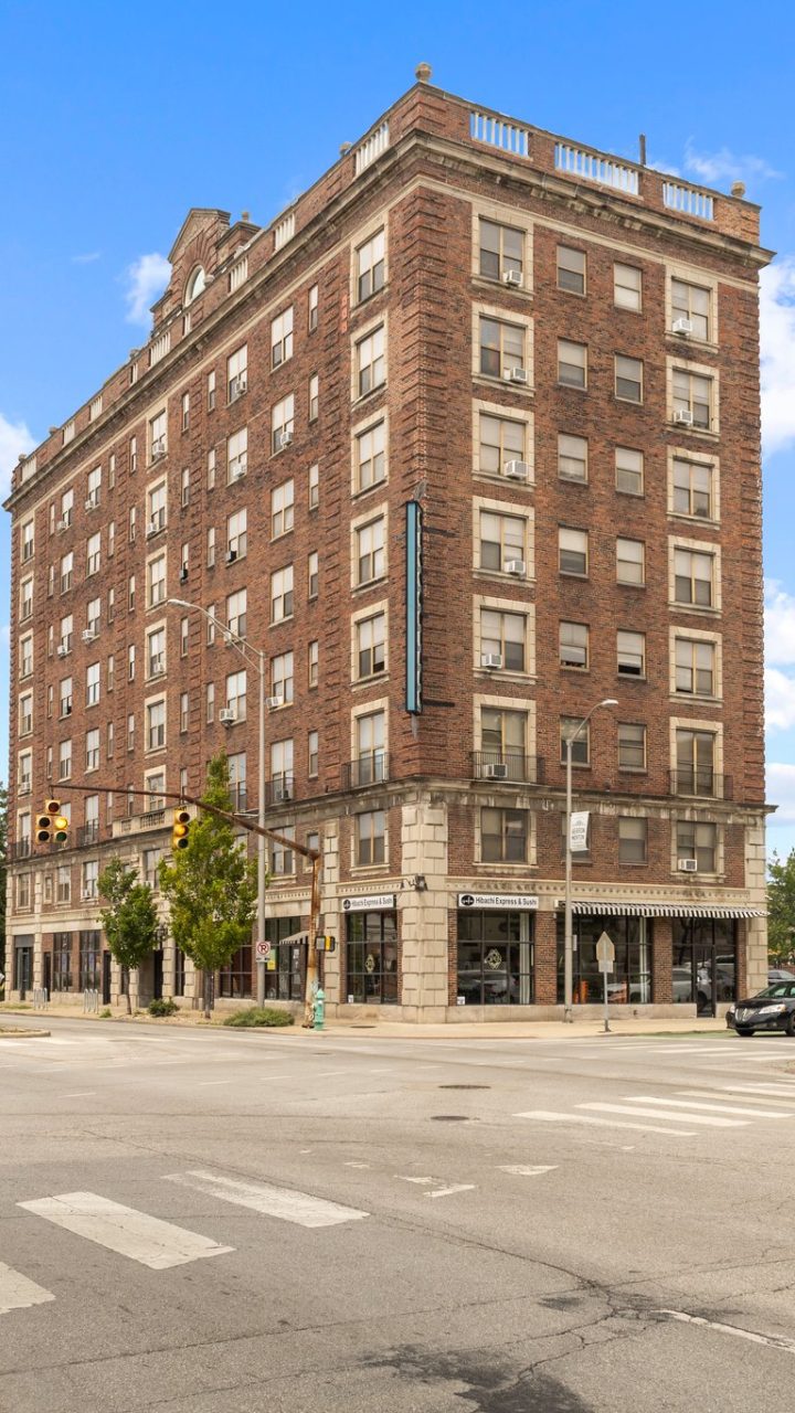 a large brick building on a corner in a city at The Piccadilly Apartments
